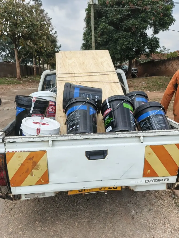 Paint buckets and timber loaded on a pickup